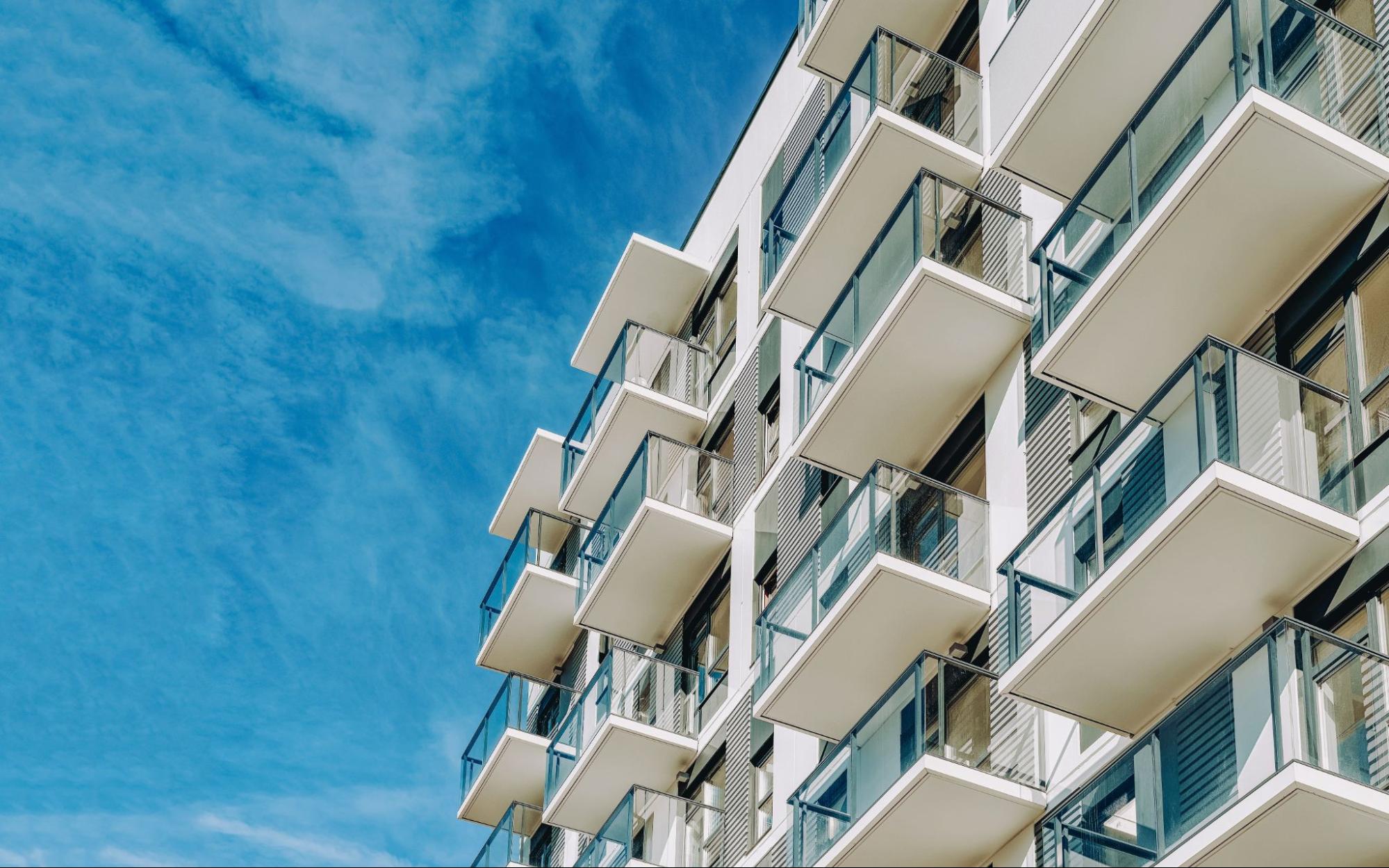 Modern luxury condo developments in Clearwater featuring white balconies and glass railings against a clear blue sky, illustrating the rise of high-end coastal living for 2026.